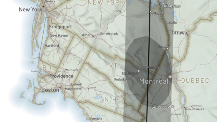 A screenshot from an interactive map of the 2024 North American Eclipse, created by Andy Woodruff. The map is designed such that the user can scroll downwards from the start of the eclipse, so that the orientation is rotated southwest-up. The area shown covers the north-eastern USA and Quebec. The eclipse’s path of totality is indicated by a shaded swath, and a darker ellipse indicates the region of total eclipse at a specific moment in time, which includes Montreal and Burlington.