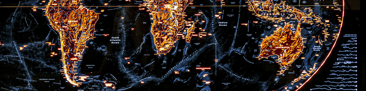 A short, wide crop of a photo of an illuminated map of the world made by Evan Applegate.